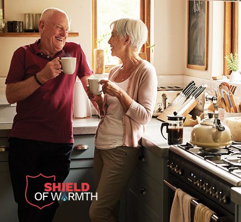 Shield of Warmth couple drinking coffee in their kitchen